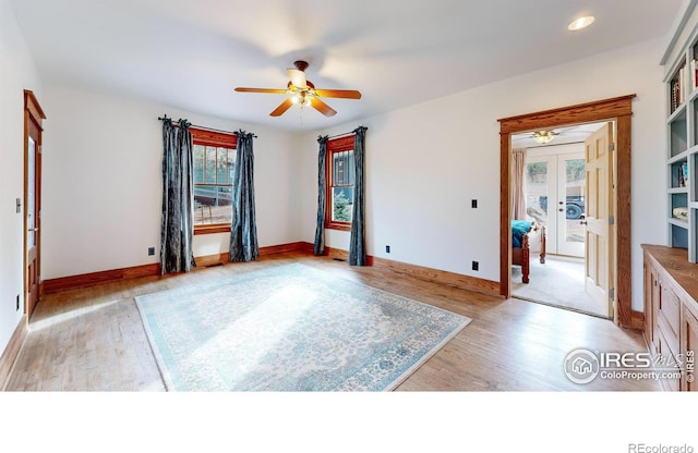 spare room with ceiling fan, french doors, and light hardwood / wood-style floors