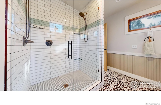 bathroom with tile patterned floors and an enclosed shower