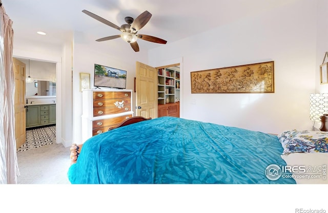 carpeted bedroom featuring ensuite bath and ceiling fan