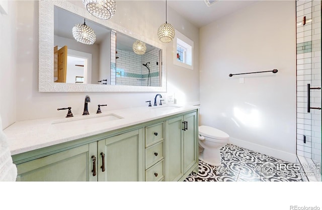 bathroom featuring toilet, vanity, tile patterned floors, and walk in shower