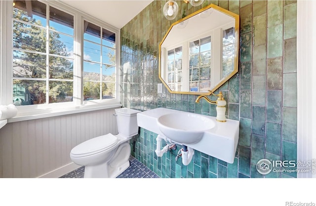 bathroom with tile patterned flooring, toilet, and sink