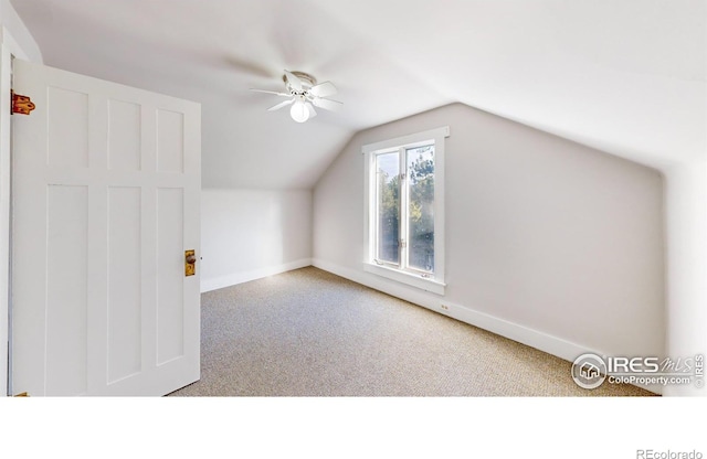 additional living space with ceiling fan, carpet, and vaulted ceiling