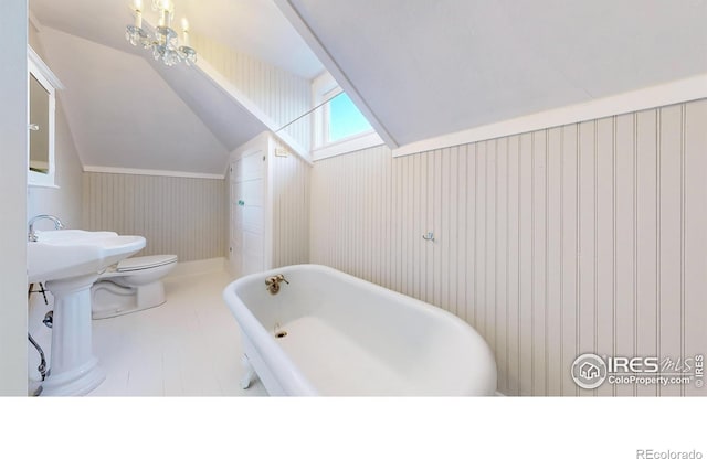 bathroom with a tub, tile patterned floors, vaulted ceiling, toilet, and wooden walls