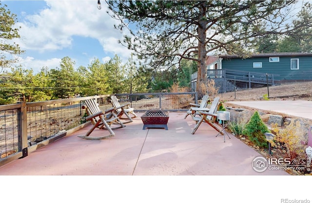 view of patio with an outdoor fire pit