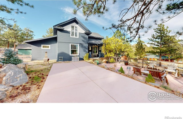 view of front of property featuring central AC and a patio area