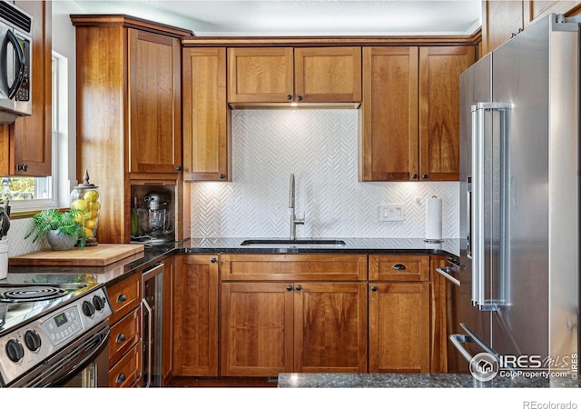 kitchen with wine cooler, appliances with stainless steel finishes, decorative backsplash, sink, and dark stone countertops