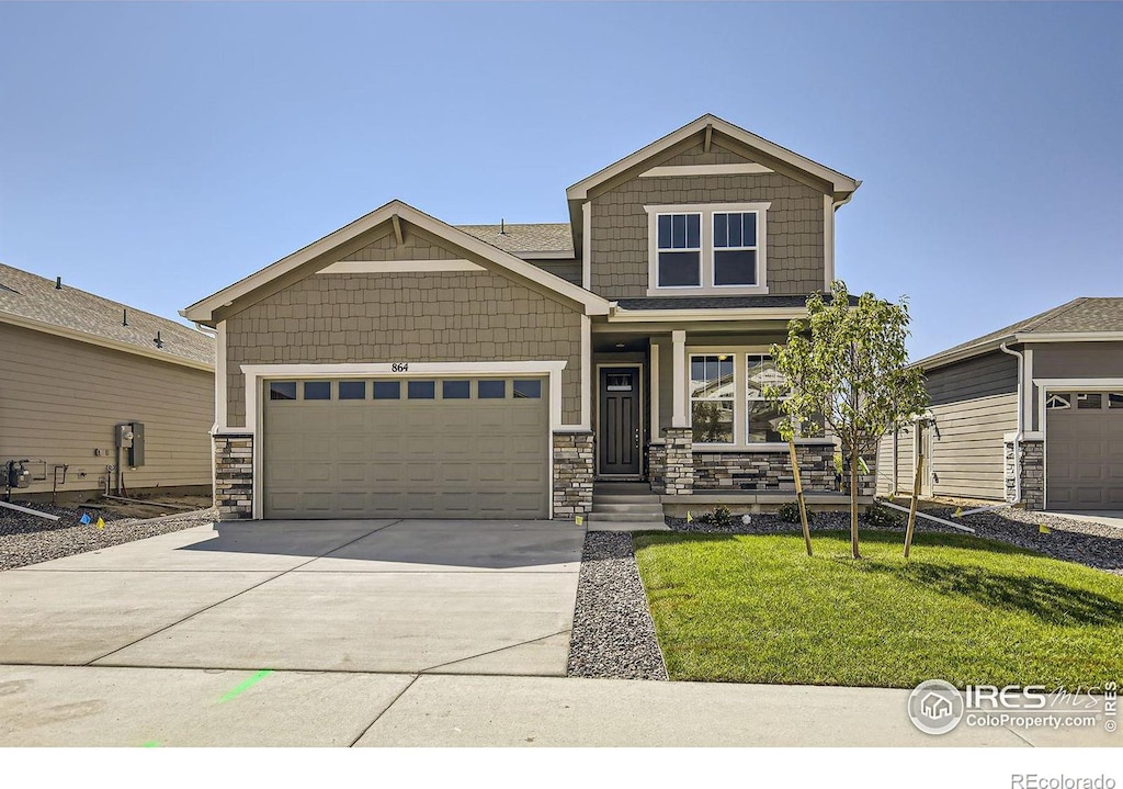 craftsman-style house with a porch, a front lawn, and a garage