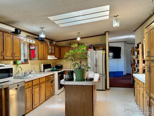 kitchen with a center island, lofted ceiling with skylight, a textured ceiling, and appliances with stainless steel finishes