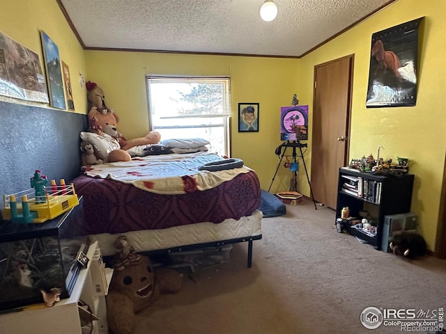 bedroom with crown molding, carpet floors, and a textured ceiling