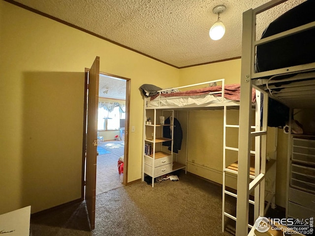 unfurnished bedroom with dark carpet, a textured ceiling, and ornamental molding