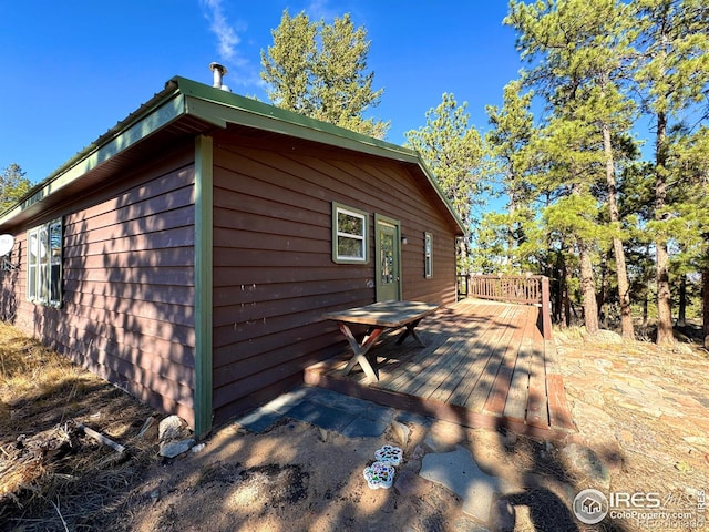 view of side of home featuring a wooden deck