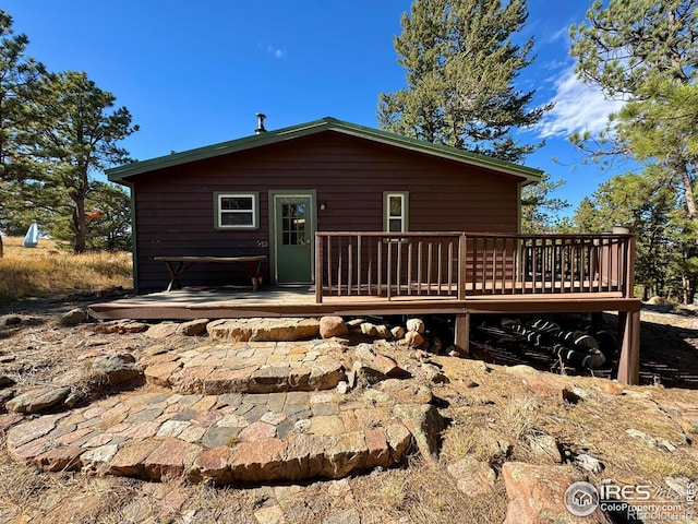 back of house featuring a deck and a patio area