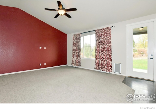 unfurnished room featuring ceiling fan, hardwood / wood-style flooring, vaulted ceiling, and plenty of natural light