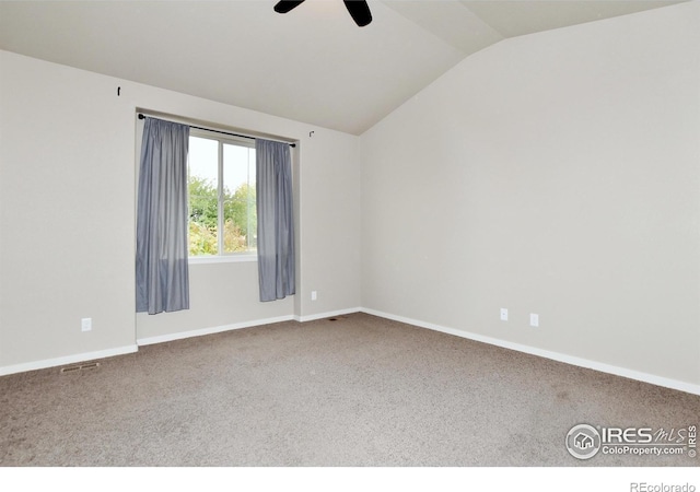 carpeted spare room featuring lofted ceiling and ceiling fan