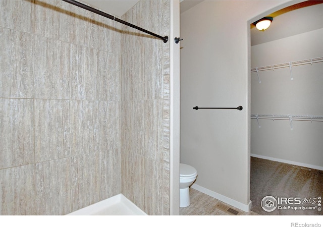 bathroom featuring toilet and walk in shower