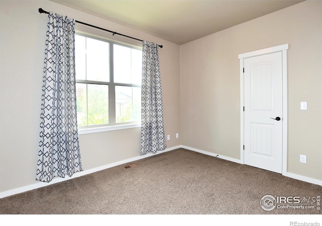 spare room with carpet and a healthy amount of sunlight