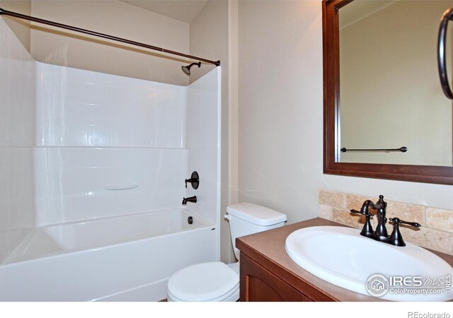 full bathroom featuring vanity, bathtub / shower combination, and toilet