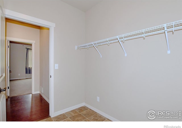 walk in closet with wood-type flooring