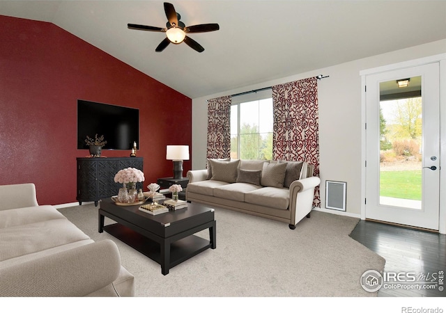 living room with ceiling fan, hardwood / wood-style flooring, and vaulted ceiling