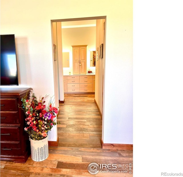 corridor with light hardwood / wood-style floors