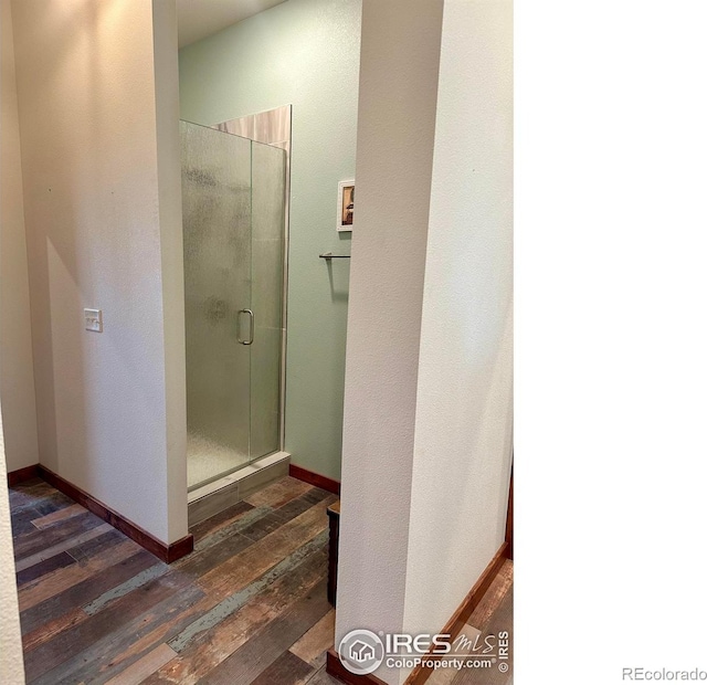 bathroom with hardwood / wood-style floors and walk in shower