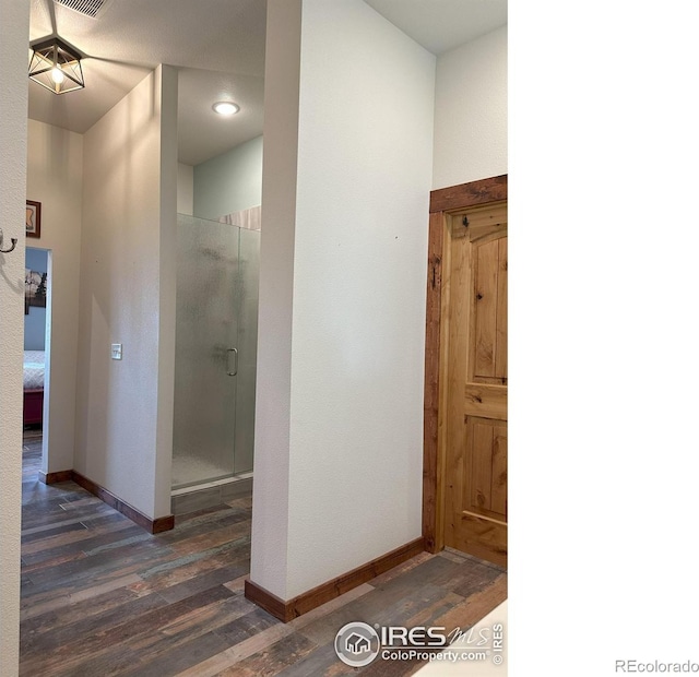 bathroom featuring a shower with door and hardwood / wood-style floors