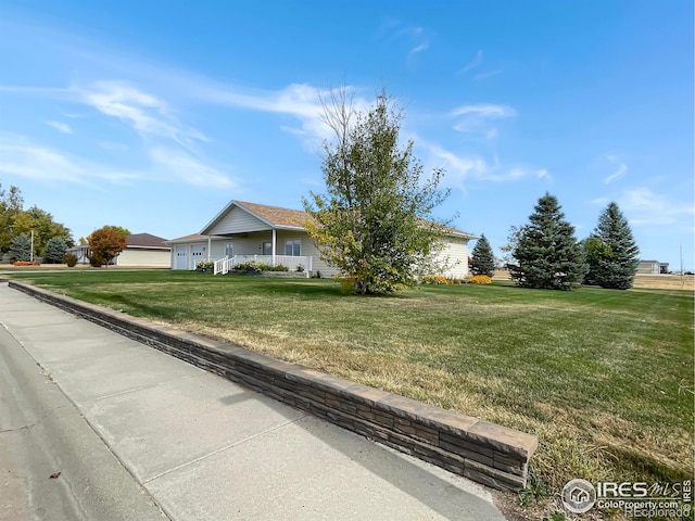 1241 S Sherman Ave, Holyoke, CO 80734 - view of front of home featuring a front lawn and an attached garage