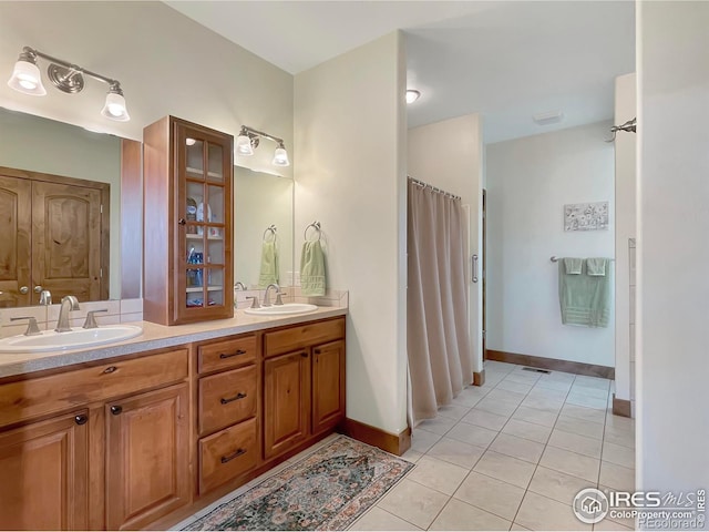 1241 S Sherman Ave, Holyoke, CO 80734 - full bath with baseboards, tile patterned flooring, double vanity, and a sink