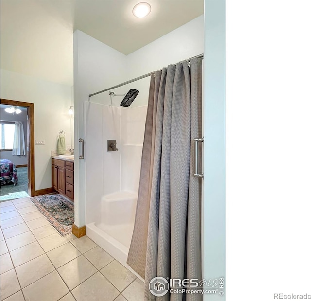 bathroom featuring tile patterned floors, vanity, and a shower with shower curtain