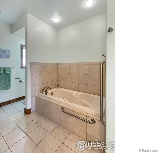 bathroom with tile patterned floors and tiled bath