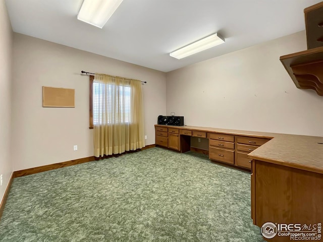 unfurnished office with light colored carpet and built in desk