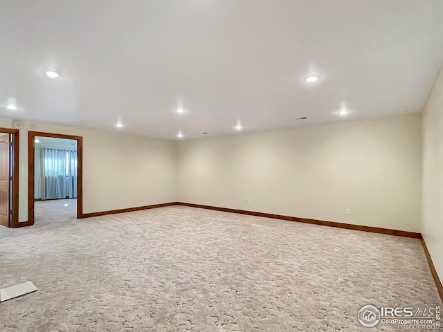 unfurnished room featuring light carpet