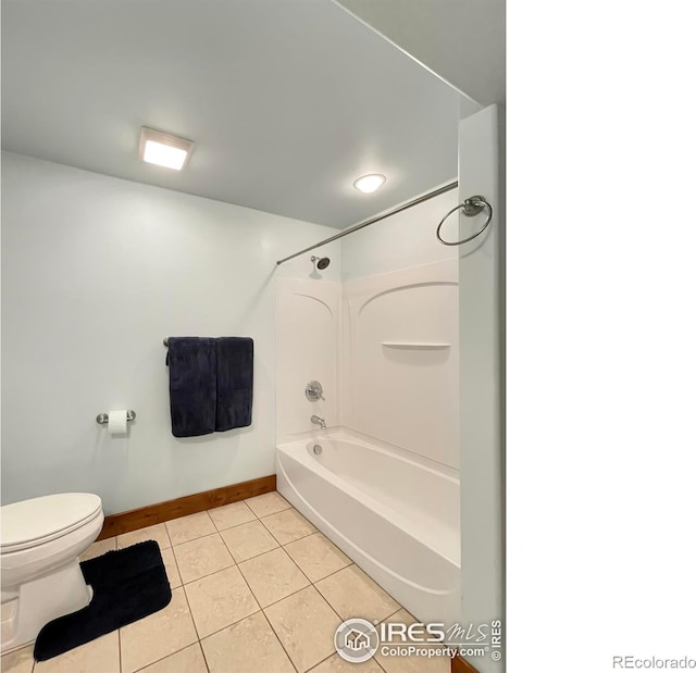 bathroom featuring tile patterned floors, bathing tub / shower combination, and toilet