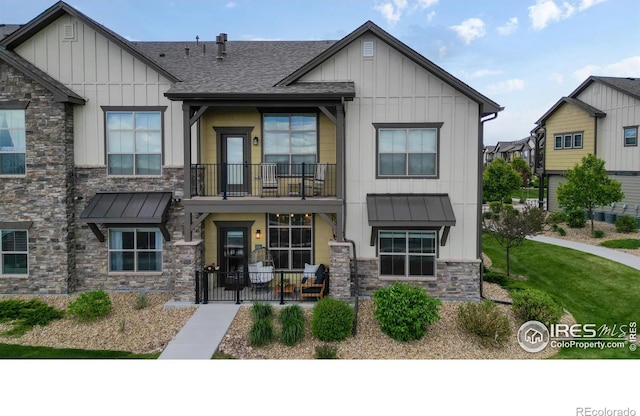 6634 Crystal Downs Dr Unit 104, Windsor, CO 80550 - view of front of home featuring board and batten siding, stone siding, and a standing seam roof