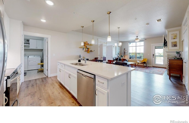 6634 Crystal Downs Dr Unit 104, Windsor, CO 80550 - kitchen featuring stainless steel dishwasher, range with electric stovetop, washer and clothes dryer, light wood-style flooring, and recessed lighting