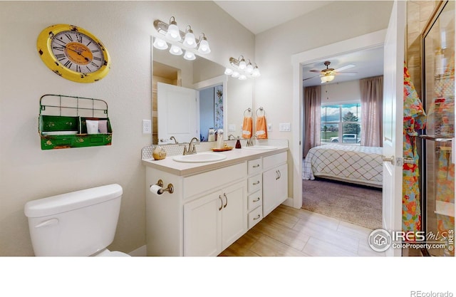 6634 Crystal Downs Dr Unit 104, Windsor, CO 80550 - bathroom featuring toilet, double vanity, ensuite bath, ceiling fan, and a stall shower
