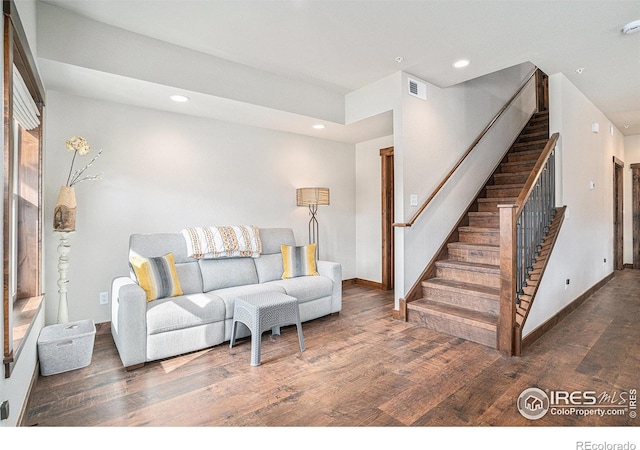 living room with dark hardwood / wood-style flooring