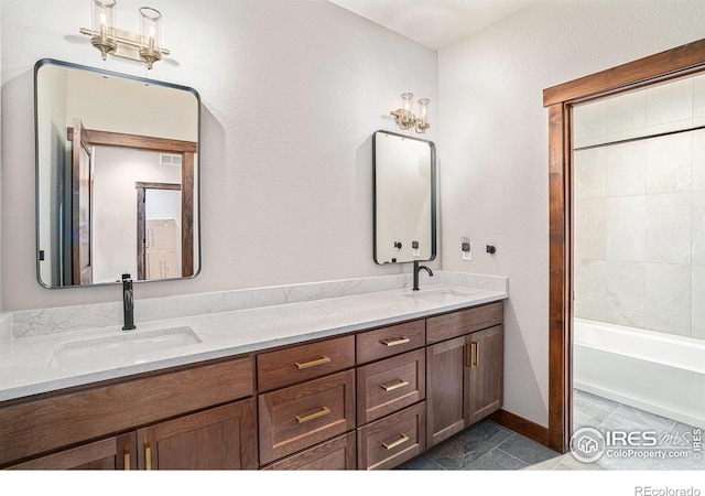 bathroom featuring vanity, a bath, and tile patterned flooring