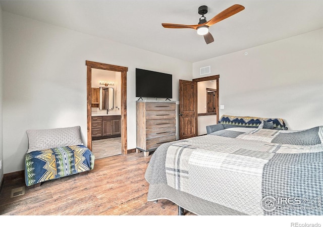 bedroom with ensuite bathroom, light wood-type flooring, and ceiling fan