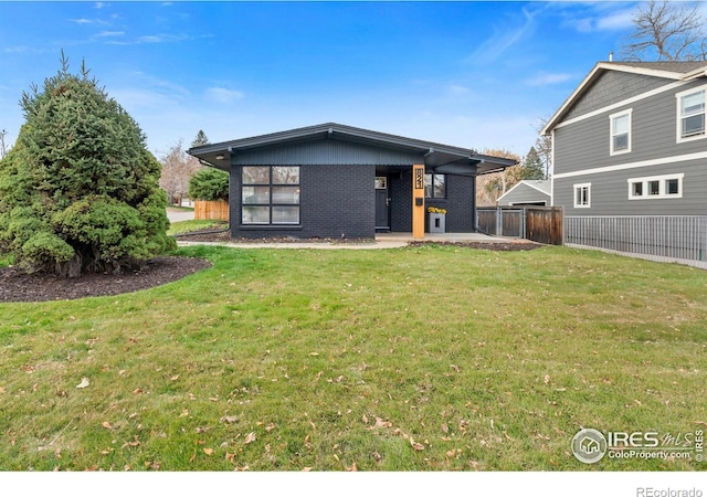 rear view of property featuring a lawn