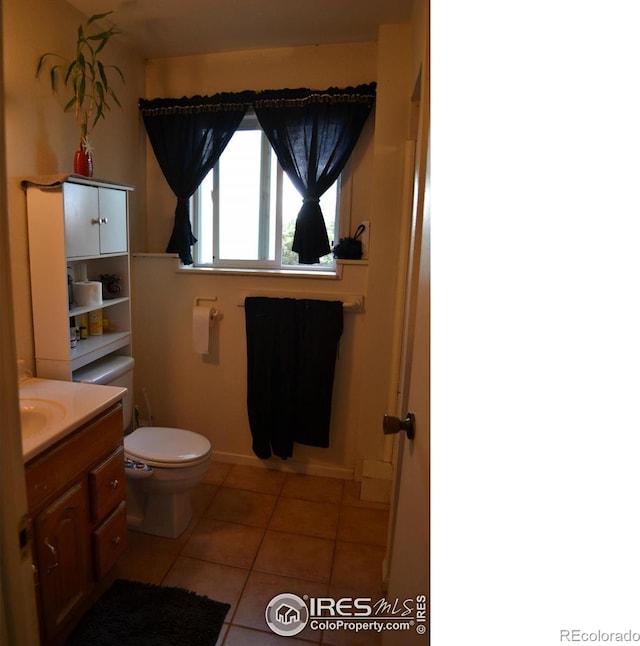 bathroom with vanity, toilet, and tile patterned flooring