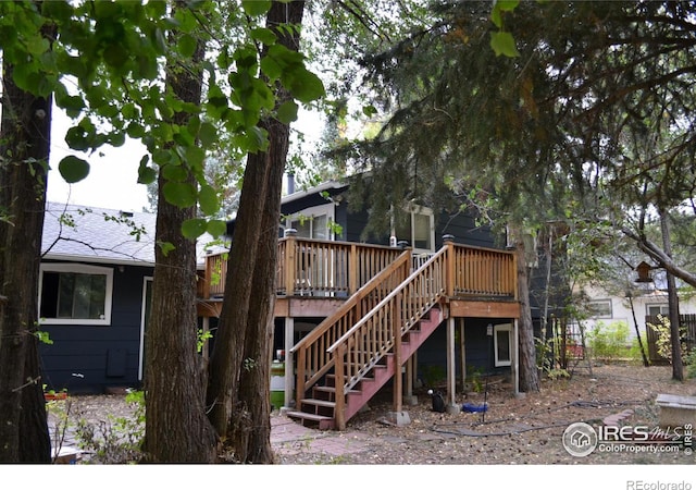 back of property with a wooden deck