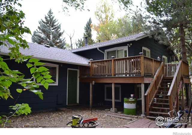 rear view of property with a wooden deck