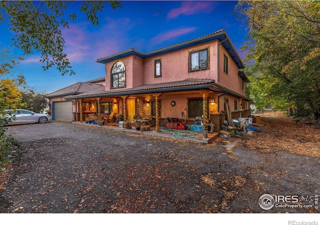 view of front of home with a porch and a garage