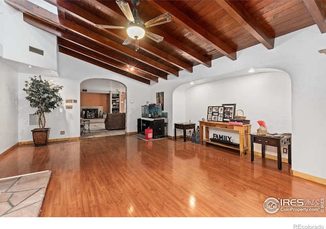 living room featuring wood ceiling, hardwood / wood-style flooring, lofted ceiling with beams, and ceiling fan