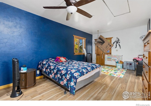 bedroom with light hardwood / wood-style floors and ceiling fan