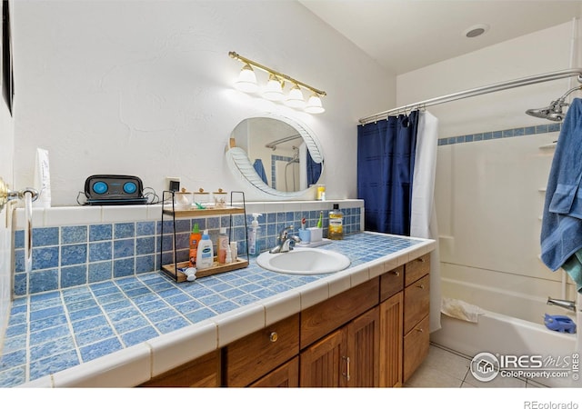 bathroom with vanity, tasteful backsplash, shower / bathtub combination with curtain, and tile patterned flooring