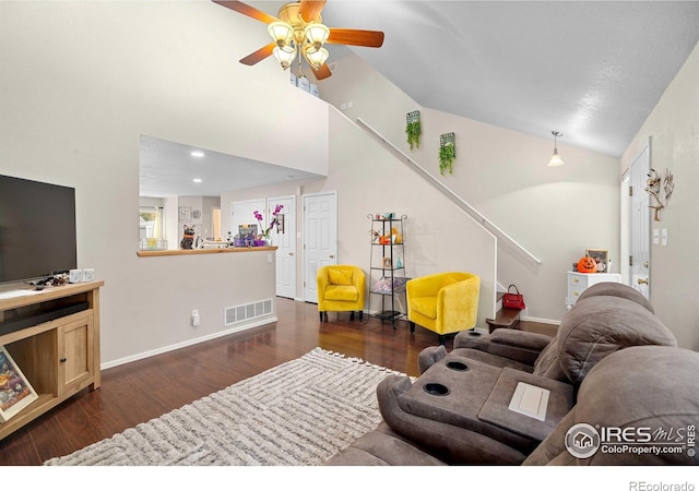 living room featuring vaulted ceiling, ceiling fan, and dark hardwood / wood-style flooring