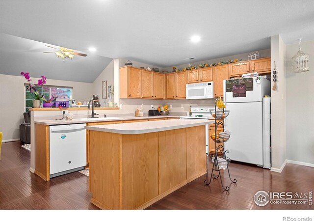 kitchen featuring lofted ceiling, light brown cabinetry, dark wood-type flooring, a center island, and white appliances