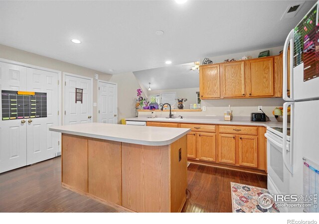 kitchen with a kitchen island, dark wood-type flooring, sink, white appliances, and ceiling fan